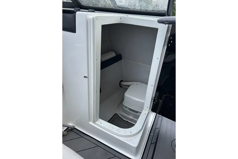 Slide: The Image of 2019 Rinker Q3 OB boat interior with compact marine toilet. - 12