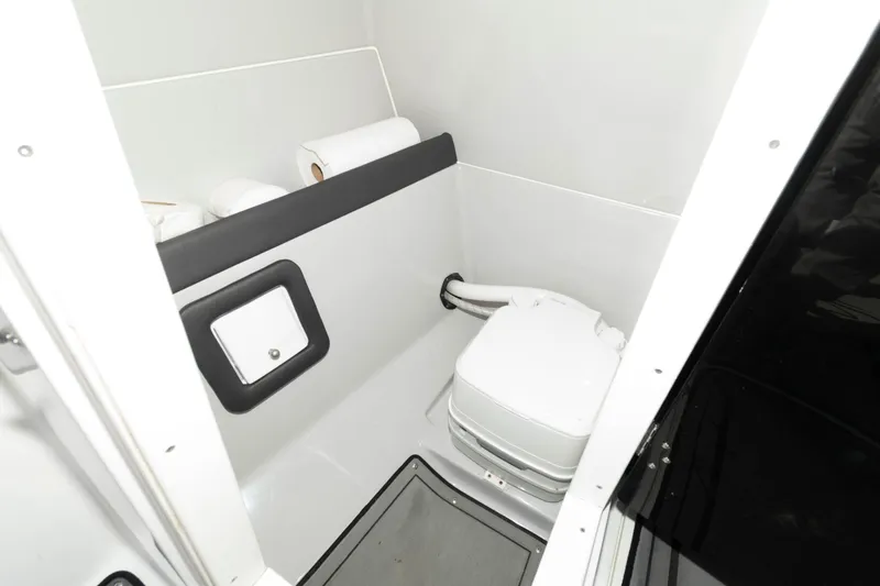 Slide: The Image of 2019 Rinker Q3 OB boat bathroom with portable toilet and storage space. - 14