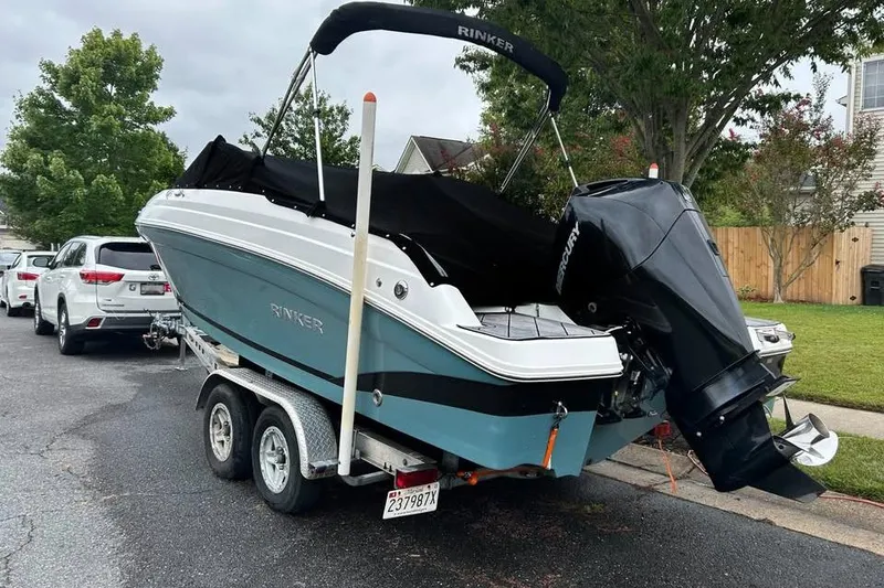 Slide: The Image of 2019 Rinker Q3 OB boat on trailer with outboard motor, parked on street. - 3