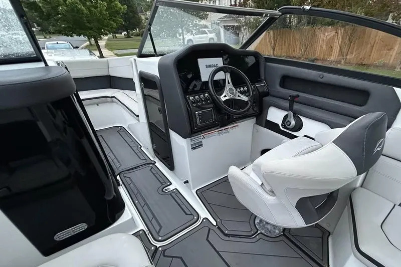 Slide: The Image of 2019 Rinker Q3 OB boat interior with steering wheel and seating. - 7