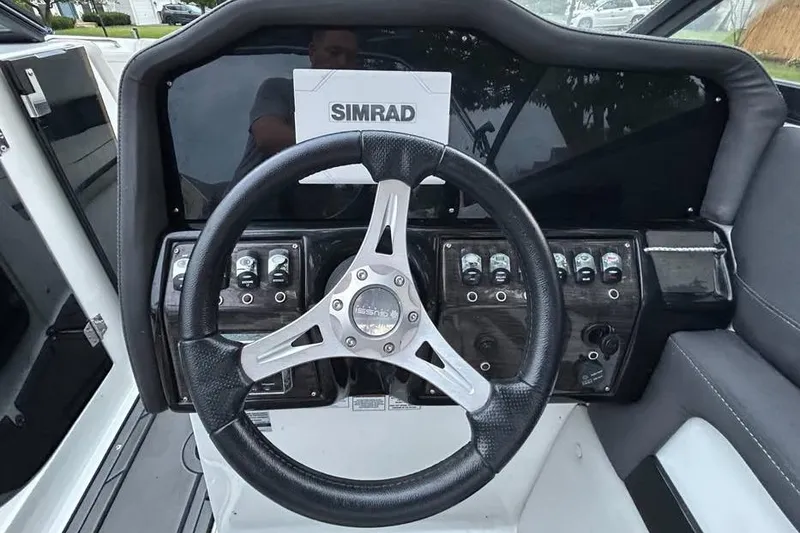 Slide: The Image of Steering wheel and dashboard of 2019 Rinker Q3 OB boat with Simrad display. - 8
