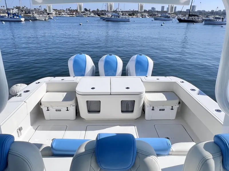 Slide: The Image of 2018 HCB 39 Speciale boat with blue seating, docked in a marina. - 14