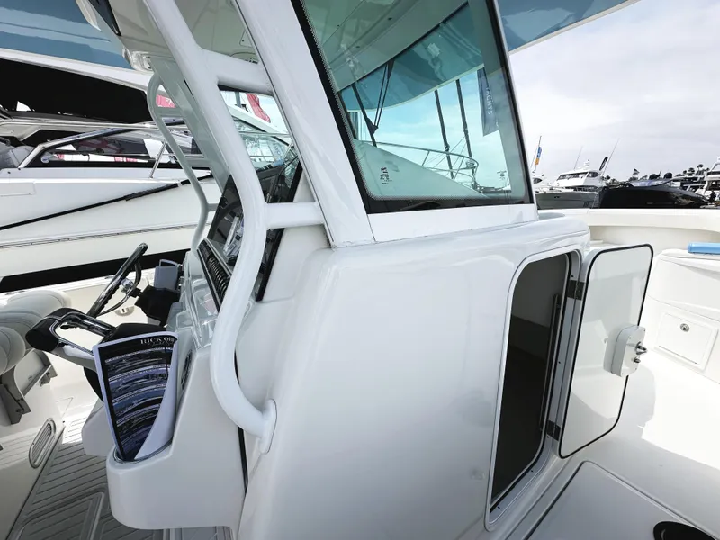 Slide: The Image of 2018 HCB 39 Speciale boat cockpit with open cabin door and steering wheel. - 26