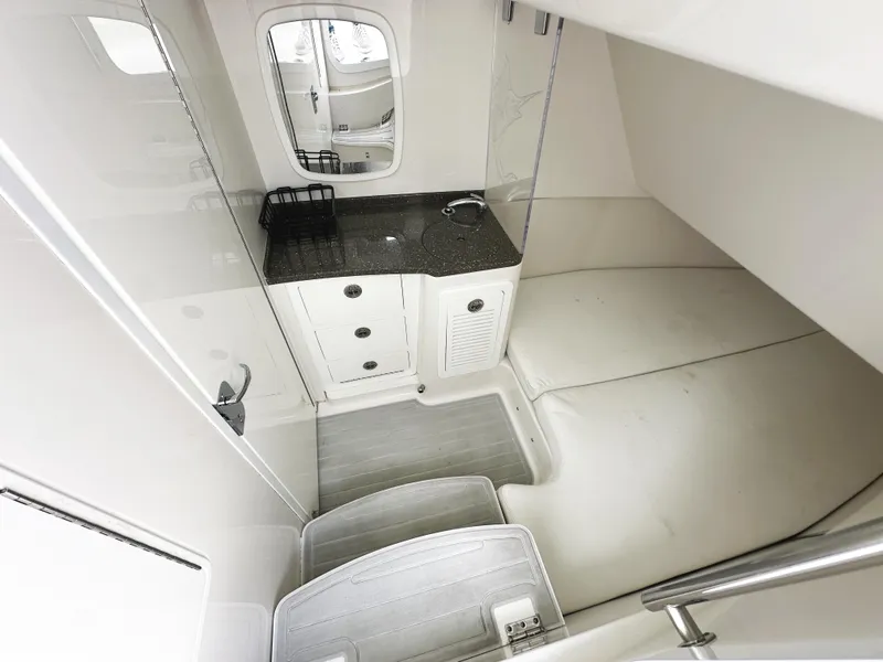 Slide: The Image of Interior cabin of 2018 HCB 39 Speciale boat, featuring a compact kitchenette and seating area. - 34