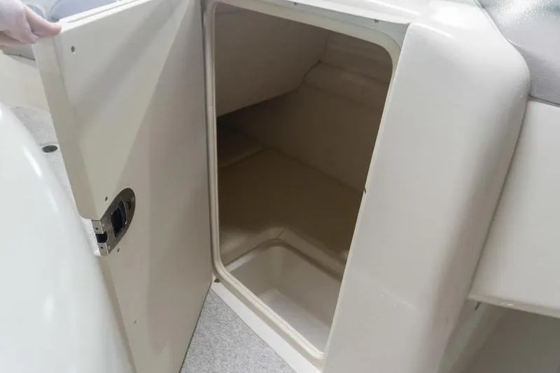 Slide: The Image of Open storage compartment on a 2002 Sea Ray 270 Sundeck boat. - 13