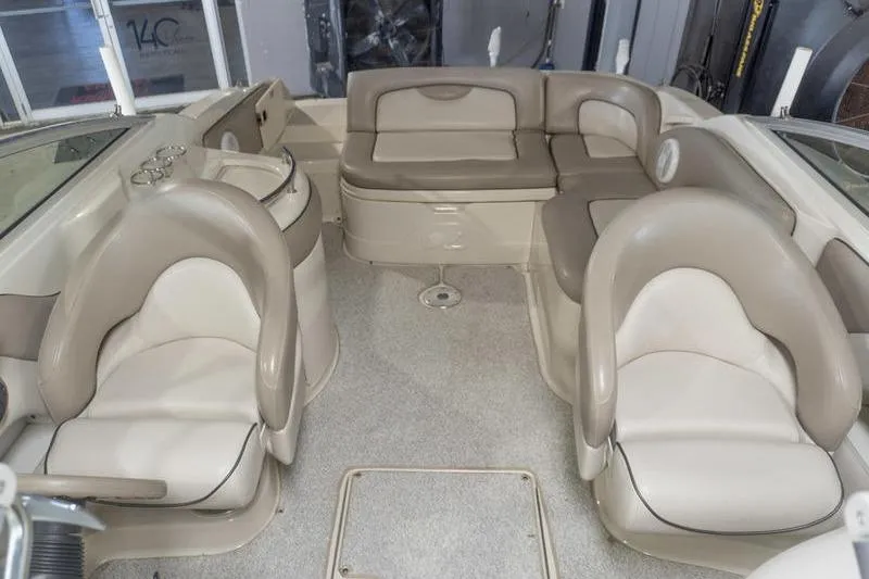 Slide: The Image of Interior of a 2002 Sea Ray 270 Sundeck boat with beige seating. - 15