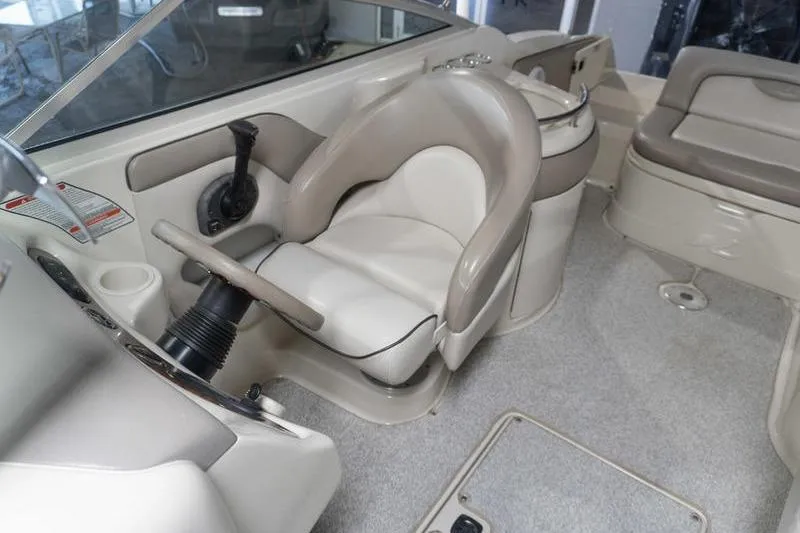 Slide: The Image of Interior of a 2002 Sea Ray 270 Sundeck boat, featuring helm and seating area. - 16