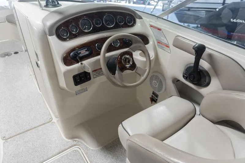 Slide: The Image of Interior cockpit of 2002 Sea Ray 270 Sundeck with steering wheel and control panel. - 17