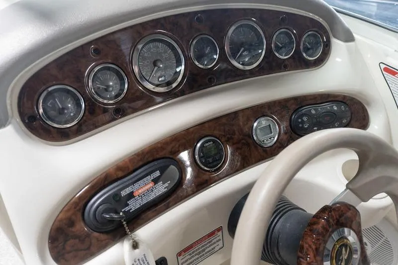Slide: The Image of Dashboard of a 2002 Sea Ray 270 Sundeck boat with gauges and controls. - 18