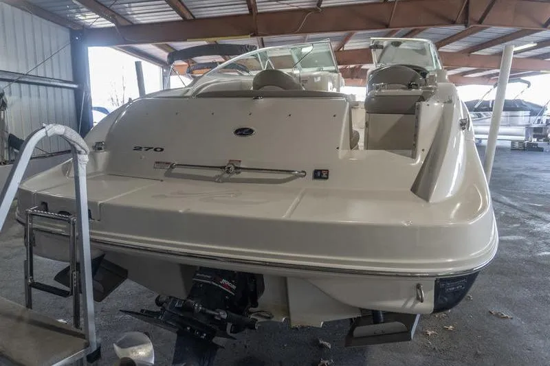 Slide: The Image of 2002 Sea Ray 270 Sundeck boat in covered storage, rear view. - 2