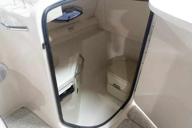 Slide: The Image of Interior cabin of 2002 Sea Ray 270 Sundeck boat, featuring compact restroom facilities. - 22