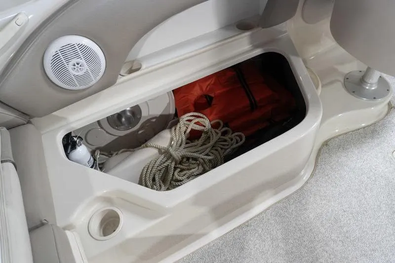 Slide: The Image of Storage compartment in 2002 Sea Ray 270 Sundeck with rope and safety equipment. - 26