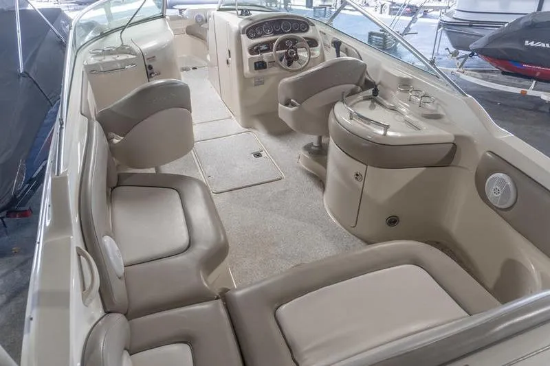 Slide: The Image of Interior of a 2002 Sea Ray 270 Sundeck boat, featuring seating and helm controls. - 4