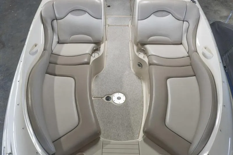 Slide: The Image of 2002 Sea Ray 270 Sundeck interior with beige seating and carpeted floor. - 7