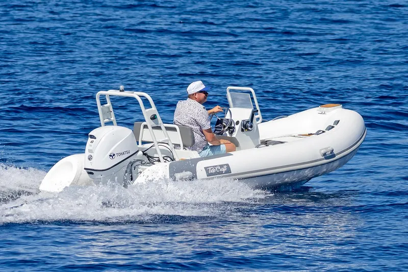 Slide: The Image of Manufacturer Provided Image: 2025 Tide Craft Catalina 13 boat cruising on open water. - 2