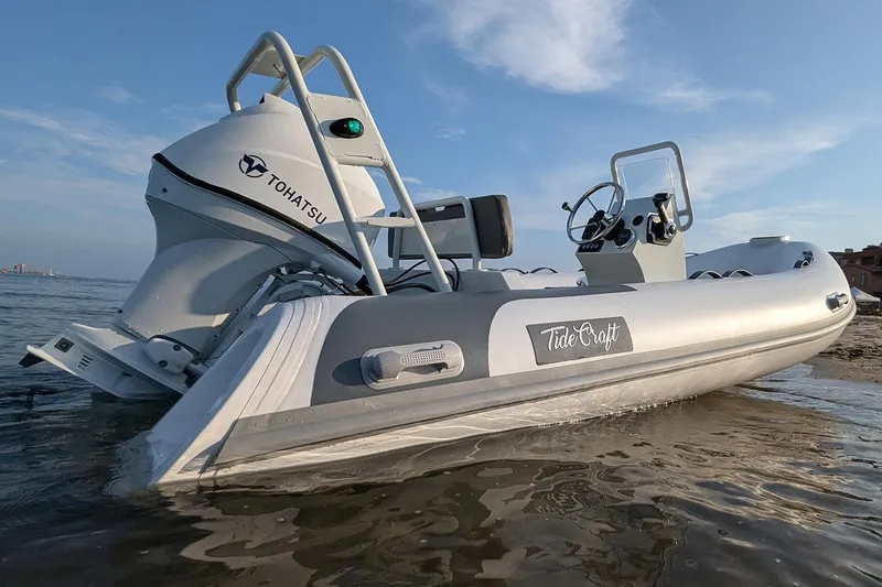 Slide: The Image of Manufacturer Provided Image: 2025 Tide Craft Catalina 13 boat with Tohatsu engine on a sandy shore. - 5