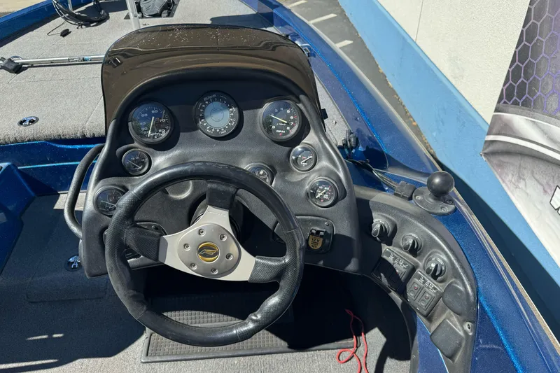 Slide: The Image of Dashboard of a 2000 Nitro 901 CDX DC boat with steering wheel and gauges. - 16