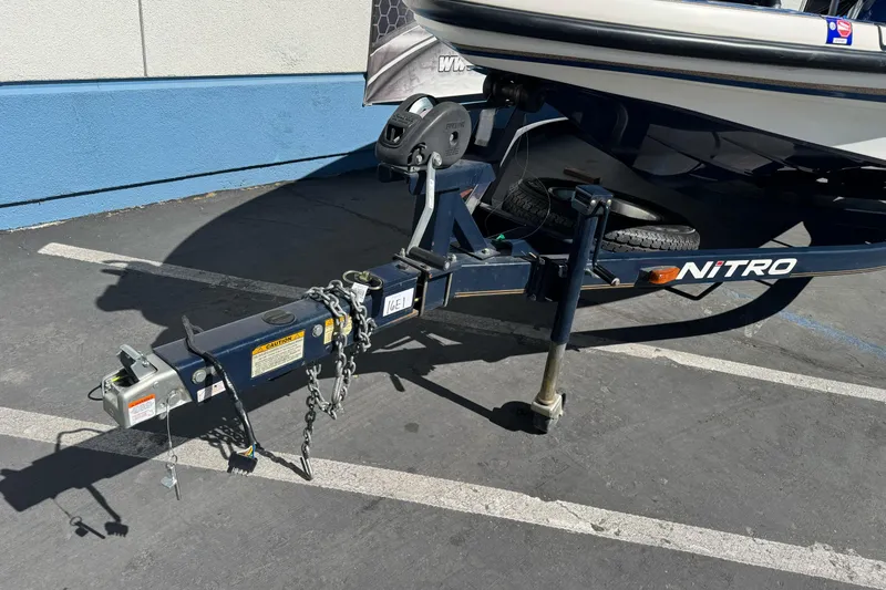 Slide: The Image of Trailer hitch of a 2000 Nitro 901 CDX DC boat in a parking lot. - 4