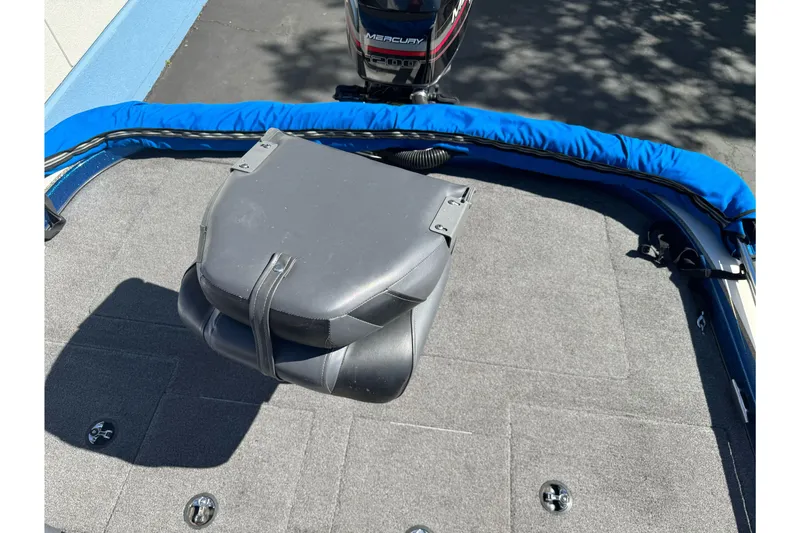 Slide: The Image of 2000 Nitro 901 CDX DC boat deck with Mercury motor, blue trim, and gray carpet. - 9