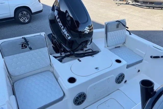 Slide: The Image of 2026 Carolina Skiff 21 LS boat interior with Suzuki engine and cushioned seating. - 11