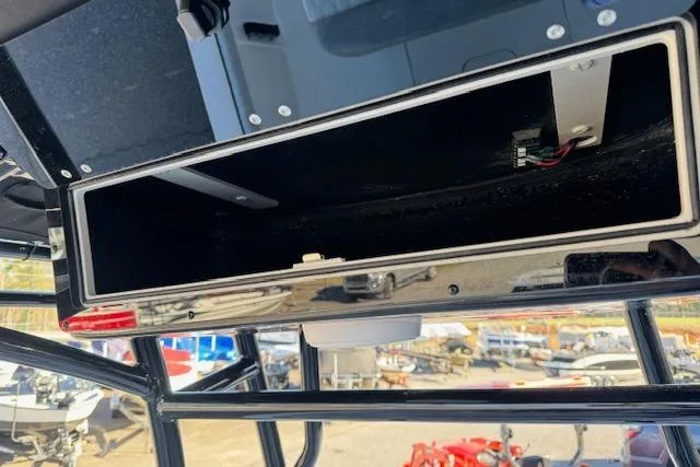 Slide: The Image of Storage compartment on a 2026 Carolina Skiff 21 LS boat, featuring sleek design and wiring. - 12