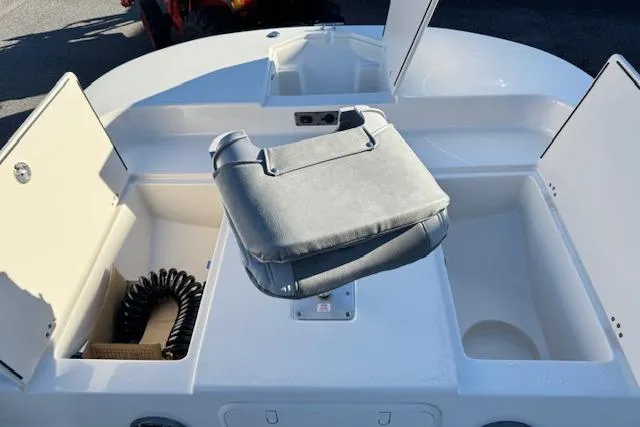 Slide: The Image of 2026 Carolina Skiff 21 LS boat interior with storage compartments and cushioned seat. - 16