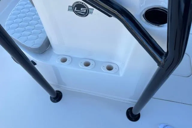 Slide: The Image of 2026 Carolina Skiff 21 LS boat console with rod holders and logo detail. - 22