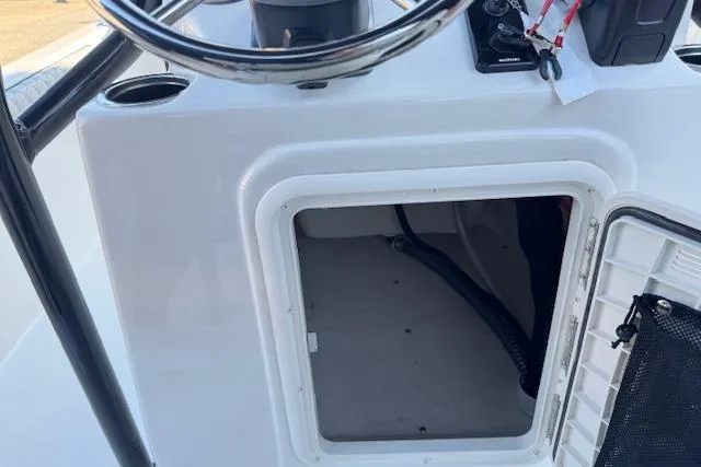 Slide: The Image of 2026 Carolina Skiff 21 LS boat console with open storage compartment. - 25