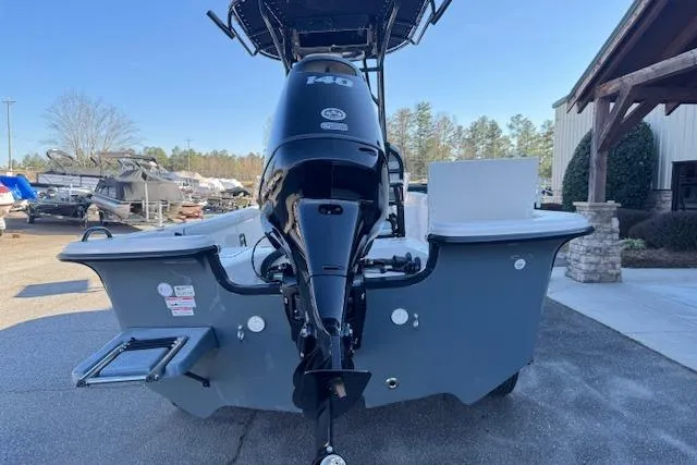 Slide: The Image of 2026 Carolina Skiff 21 LS boat with powerful outboard motor, parked outdoors. - 5