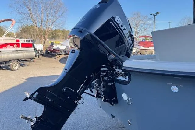 Slide: The Image of 2026 Carolina Skiff 21 LS boat with Suzuki outboard motor in a marina setting. - 7