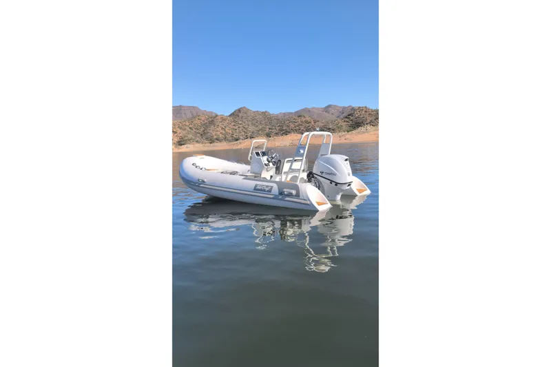 Slide: The Image of 2026 Tide Craft Catalina 13 boat on calm water with scenic mountain backdrop. - 10