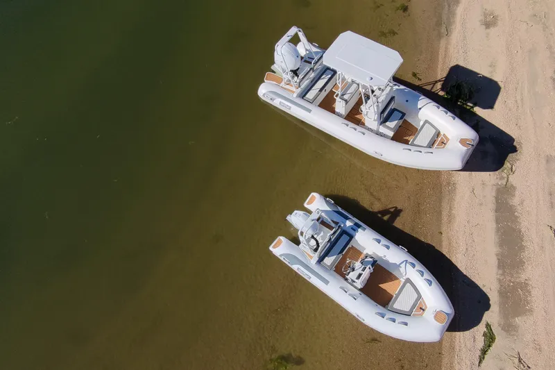 Slide: The Image of Two Tide Craft Catalina 13 boats on sandy shore, 2026 model. - 15