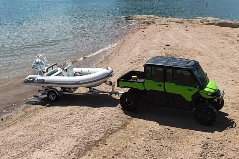 Slide: The Image of Manufacturer Provided Image: ATV towing 2025 Tide Craft Catalina 13 boat on sandy lakeside. - 3
