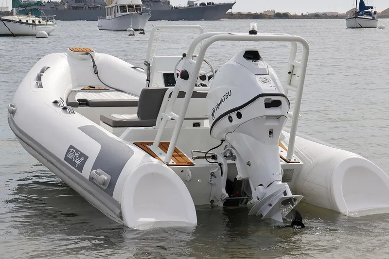 Slide: The Image of Manufacturer Provided Image: 2025 Tide Craft Catalina 13 inflatable boat with Tohatsu outboard motor in calm waters. - 6