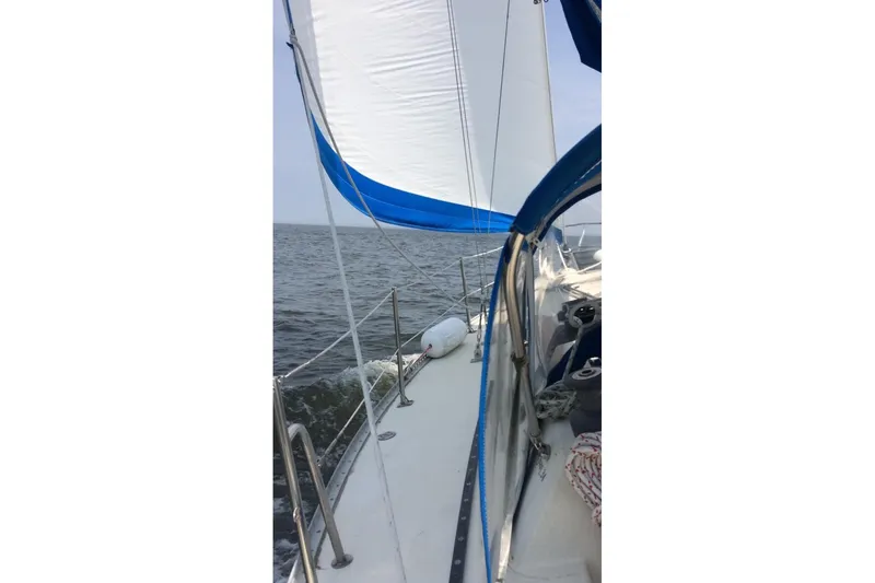 Slide: The Image of 1982 San Juan 34 sailboat cruising on open water. - 2