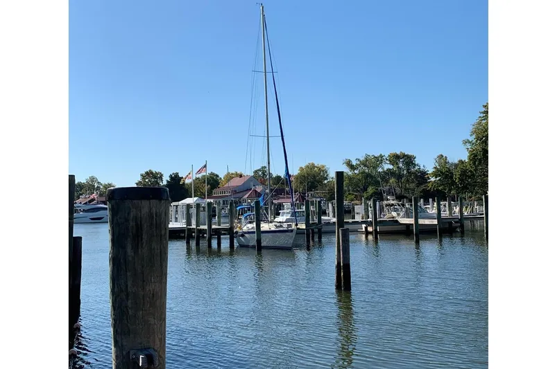 Slide: The Image of 1982 San Juan 34 sailboat docked in marina under clear sky. - 9