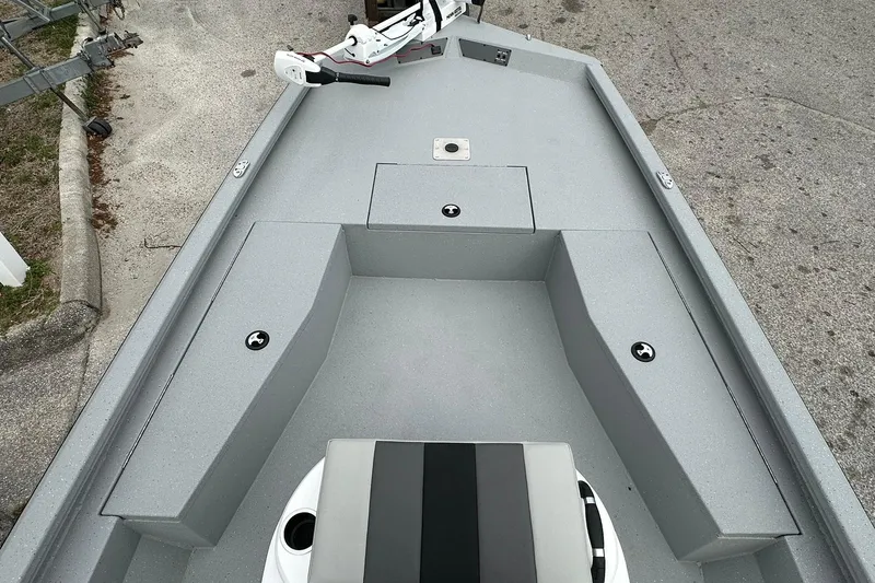 Slide: The Image of 2026 Vexus Defender 201 boat interior with gray seating and storage compartments. - 10