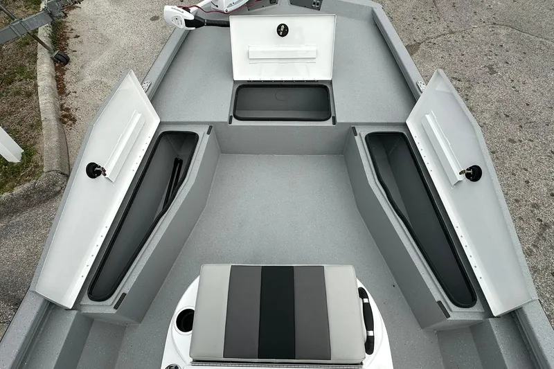 Slide: The Image of 2026 Vexus Defender 201 boat interior with open storage compartments and seating. - 11