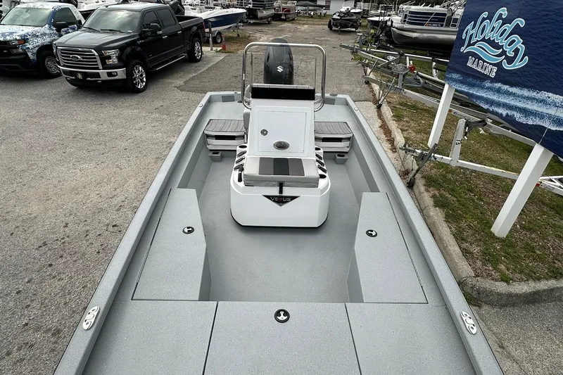 Slide: The Image of 2026 Vexus Defender 201 boat displayed at a marina with surrounding vehicles. - 13
