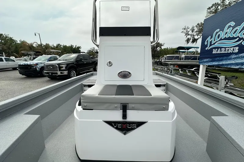 Slide: The Image of 2026 Vexus Defender 201 boat at Holiday Marine dealership, surrounded by trucks and boats. - 15