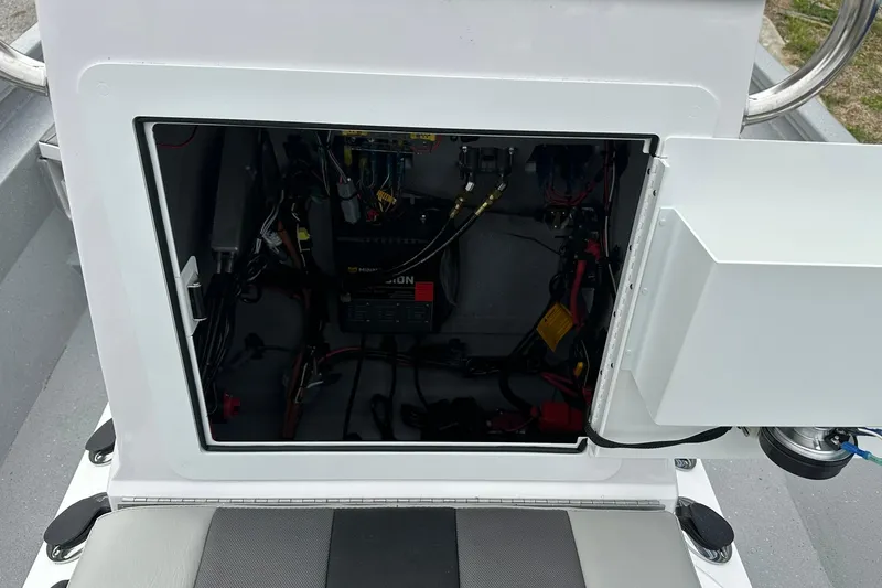 Slide: The Image of Open compartment of 2026 Vexus Defender 201 showing internal wiring and battery setup. - 19