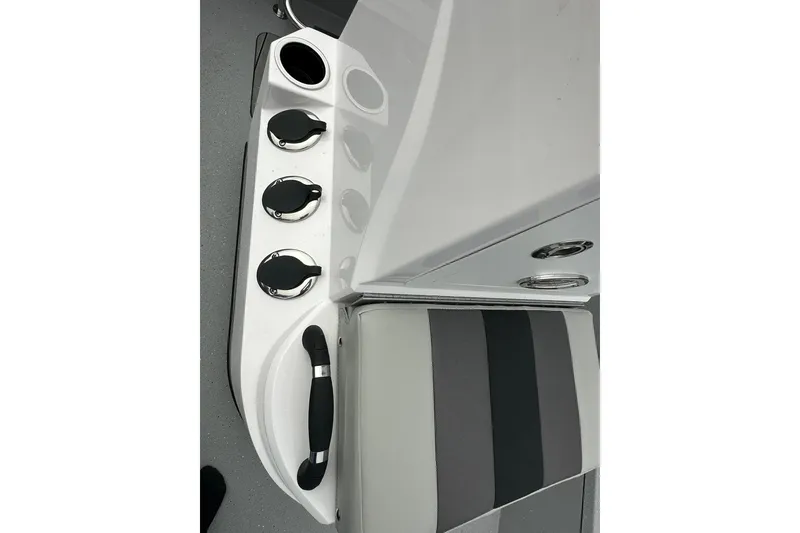 Slide: The Image of 2026 Vexus Defender 201 boat interior with cup holders and striped seating. - 20