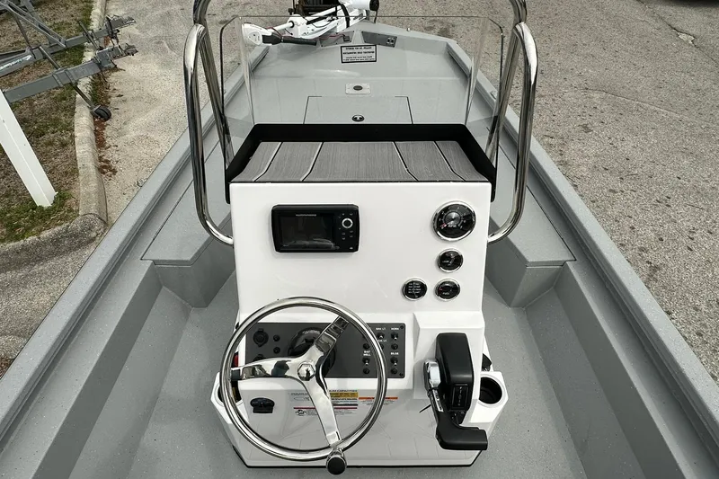 Slide: The Image of 2026 Vexus Defender 201 boat console with steering wheel and control panel. - 22