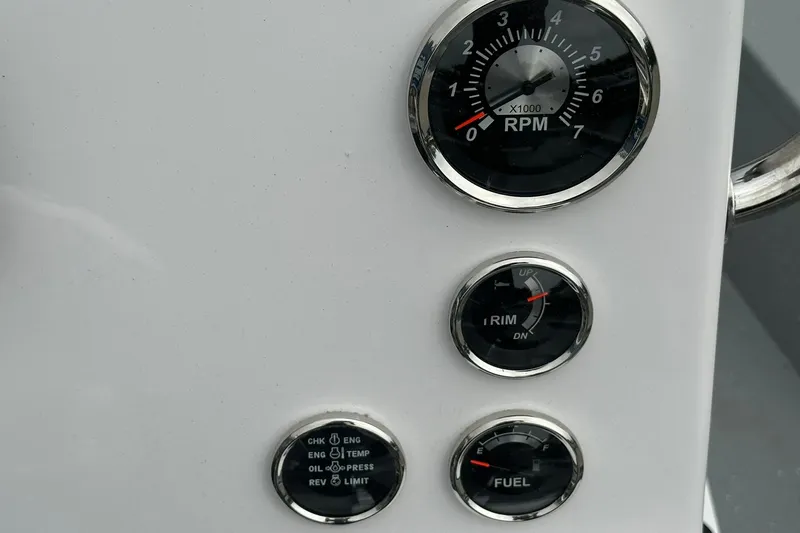 Slide: The Image of Dashboard gauges of 2026 Vexus Defender 201, showing RPM, trim, and fuel levels. - 24