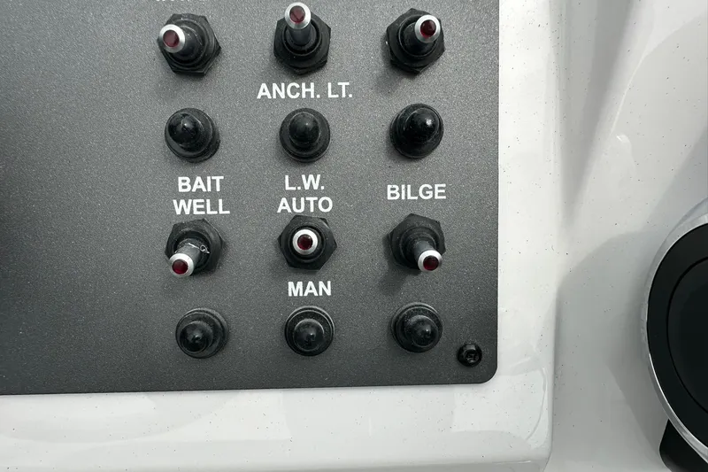 Slide: The Image of Control panel of 2026 Vexus Defender 201 boat with labeled switches. - 26