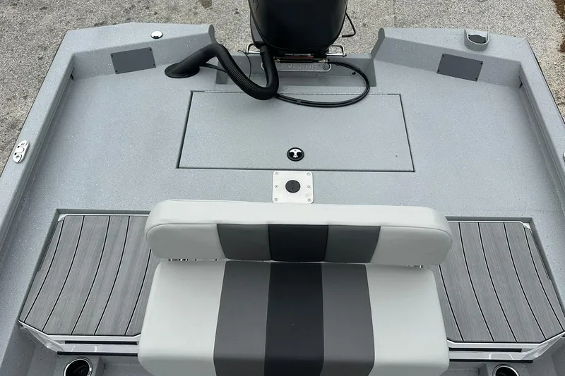Slide: The Image of 2026 Vexus Defender 201 boat interior with gray seating and deck. - 28