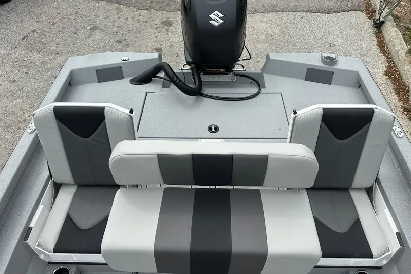 Slide: The Image of 2026 Vexus Defender 201 boat interior with gray and black seating, featuring a Suzuki engine. - 29