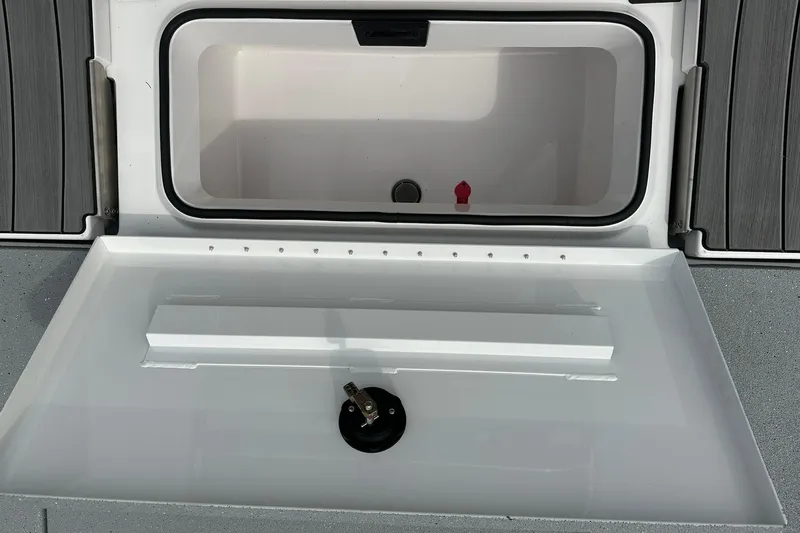 Slide: The Image of Open storage compartment of 2026 Vexus Defender 201 boat, featuring sleek design and functionality. - 32