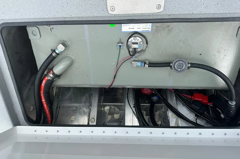 Slide: The Image of 2026 Vexus Defender 201 boat compartment with wiring and hoses. - 33