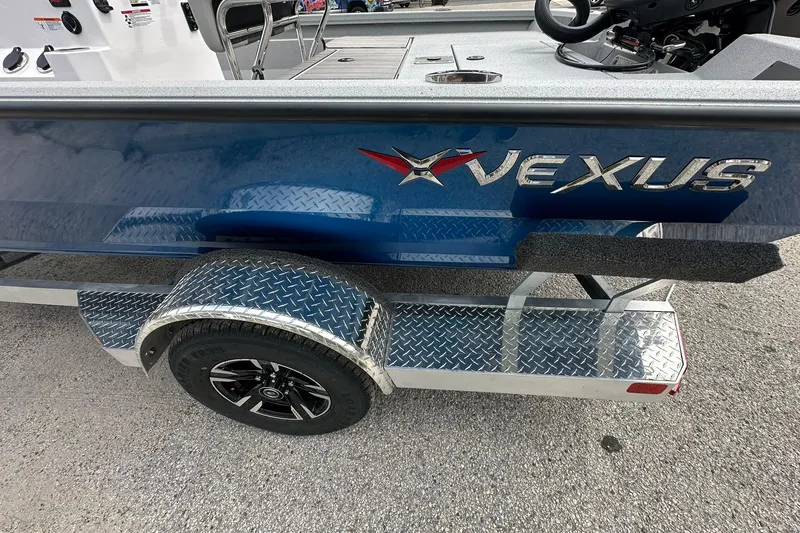Slide: The Image of 2026 Vexus Defender 201 boat on a diamond plate trailer, side view. - 34